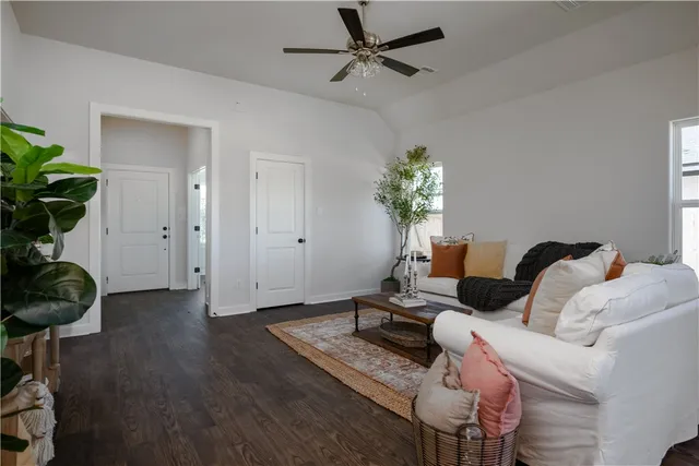 a living room with furniture and a potted plant