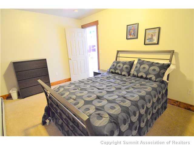 414 Big Elk Road Dillon, CO 80435 - Photo 11 of 25 a bedroom with a bed and wooden floor