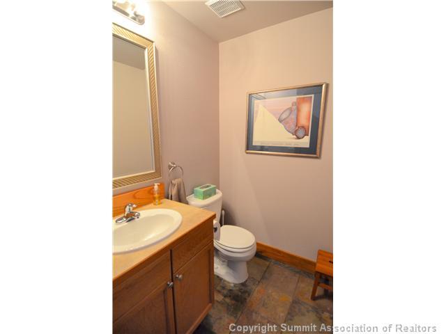414 Big Elk Road Dillon, CO 80435 - Photo 12 of 25 a bathroom with a toilet a sink and mirror