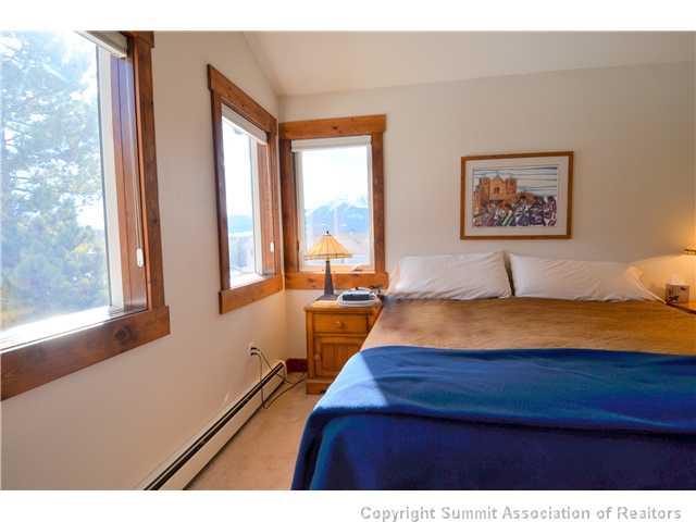 414 Big Elk Road Dillon, CO 80435 - Photo 19 of 25 a bedroom with a large bed and a window