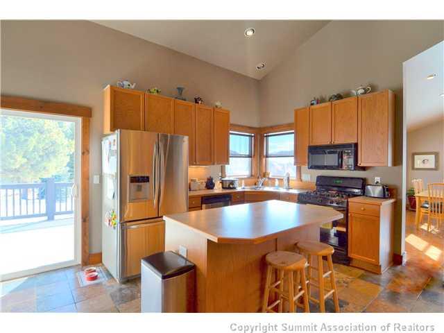 414 Big Elk Road Dillon, CO 80435 - Photo 21 of 25 a kitchen with stainless steel appliances granite countertop a refrigerator a stove and a sink with cabinets