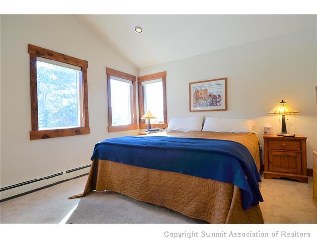 414 Big Elk Road Dillon, CO 80435 - Photo 5 of 25 a bed sitting in a bedroom next to a window