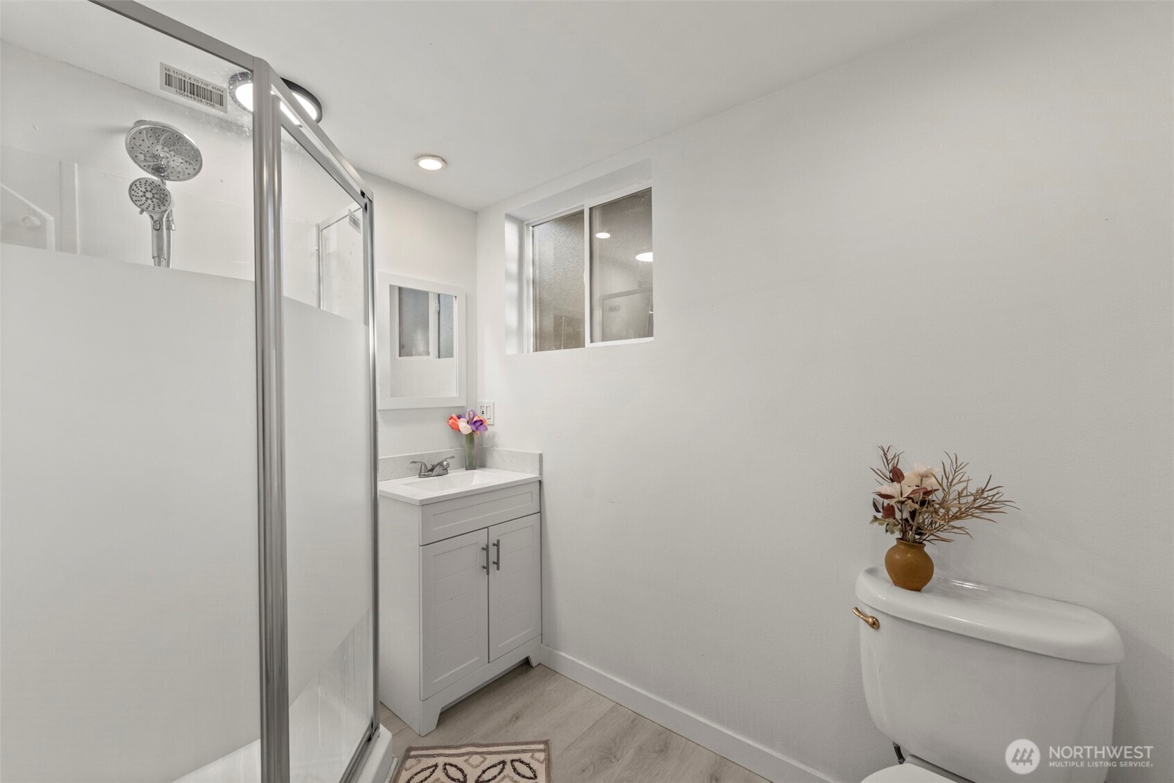 13405 Southeast 56th Place Bellevue, WA 98006 - Photo 31 of 38 a bathroom with a sink a toilet and shower