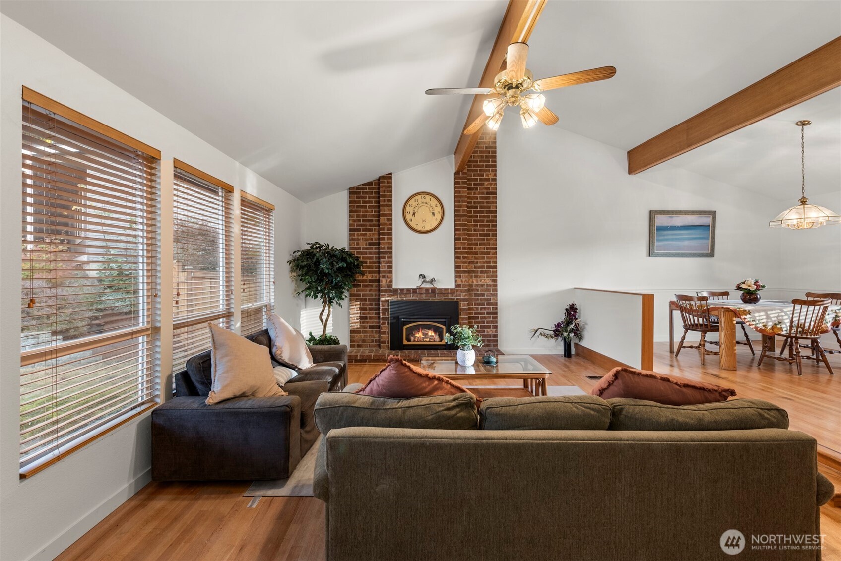 13405 Southeast 56th Place Bellevue, WA 98006 - Photo 5 of 38 a living room with furniture a fireplace and a large window