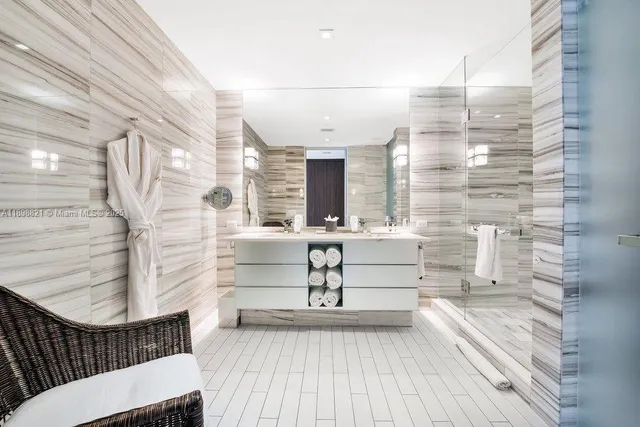 a bathroom with a sink a mirror and shower