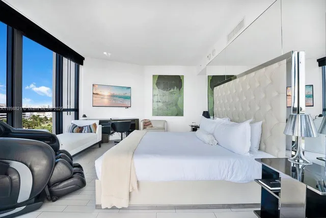 a bedroom with a large bed and a couch