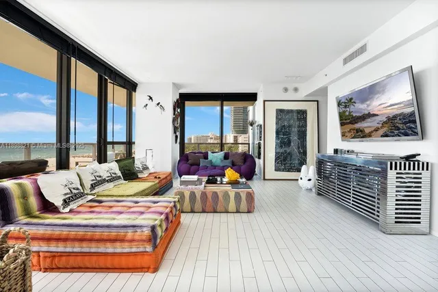 a bedroom with furniture and a large window