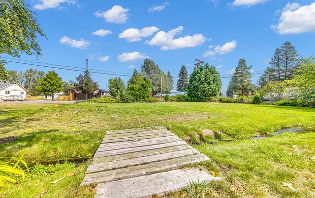 a view of a house with a backyard and sitting area