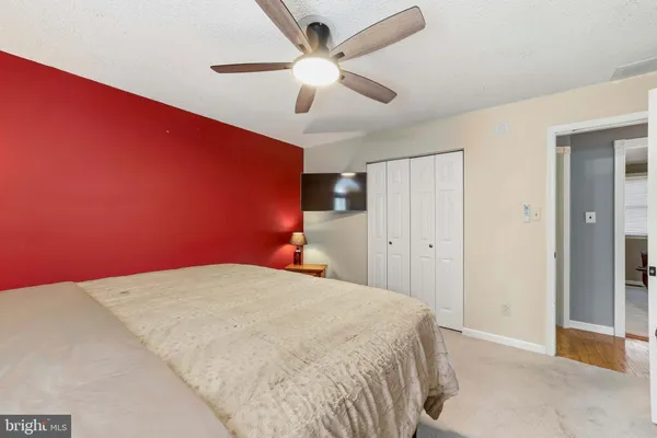 a bedroom with a bed and a ceiling fan