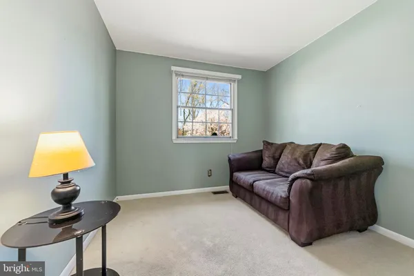 a living room with a couch and a lamp