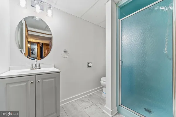 a bathroom with a sink a toilet and a mirror
