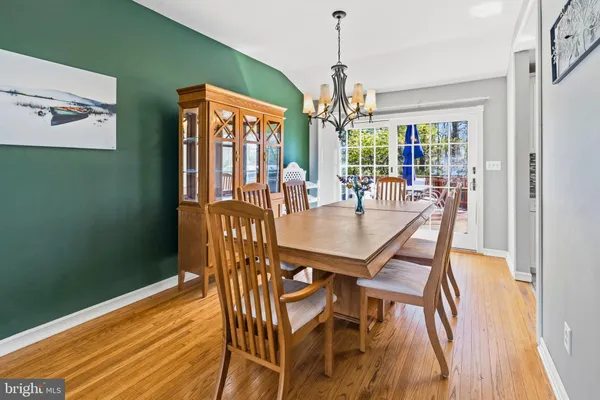 a view of a dining room with furniture wooden floor and chandelier