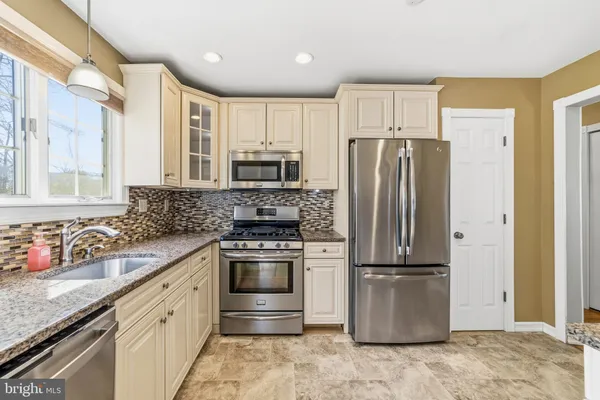 a kitchen with a refrigerator sink and microwave