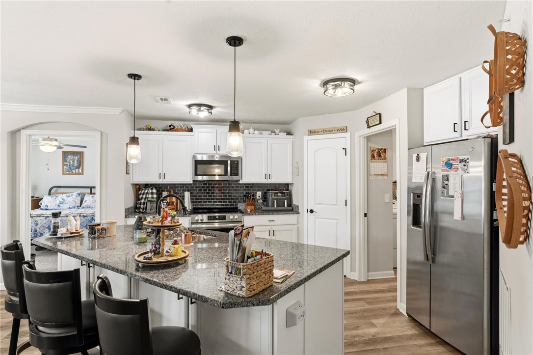 88 Old Pond Road Springboro, OH 45066 - Photo 9 of 29 This bright kitchen features an island, stainless steel appliances, and a seamless flow into adjacent living spaces.