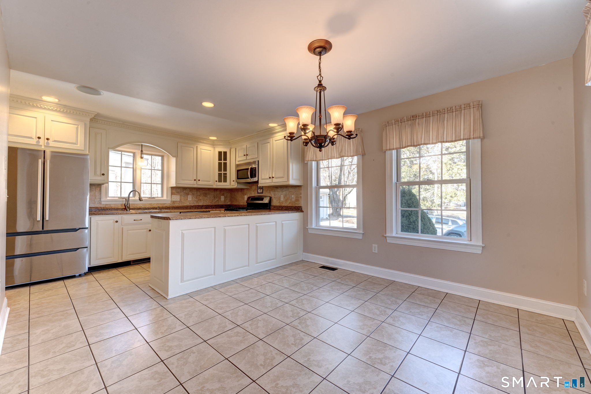 353 Warrenville Road Mansfield, CT 06250 - Photo 12 of 40 a kitchen with stainless steel appliances kitchen island granite countertop a refrigerator and a stove top oven