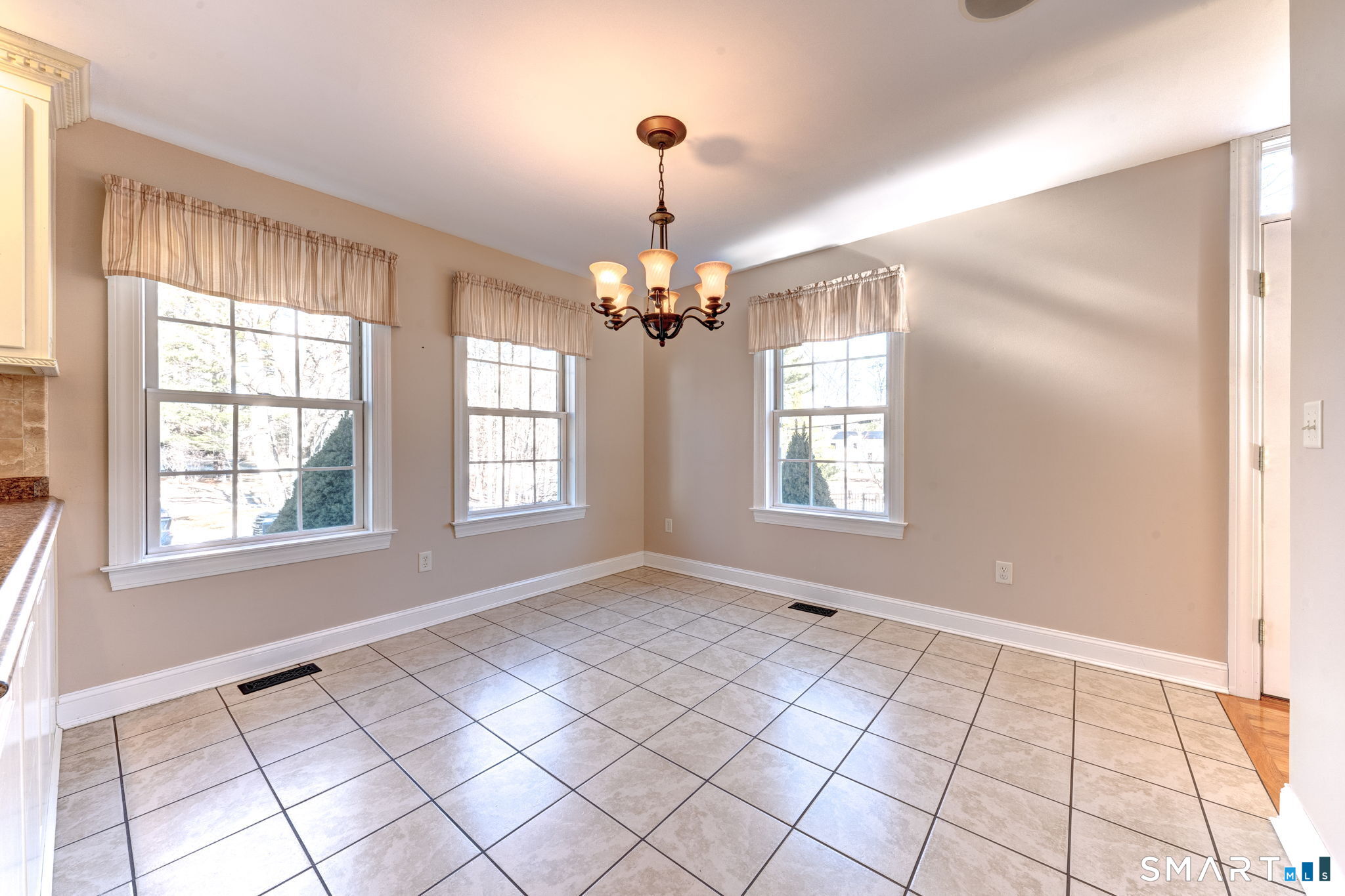 353 Warrenville Road Mansfield, CT 06250 - Photo 14 of 40 a view of an empty room with window and chandelier