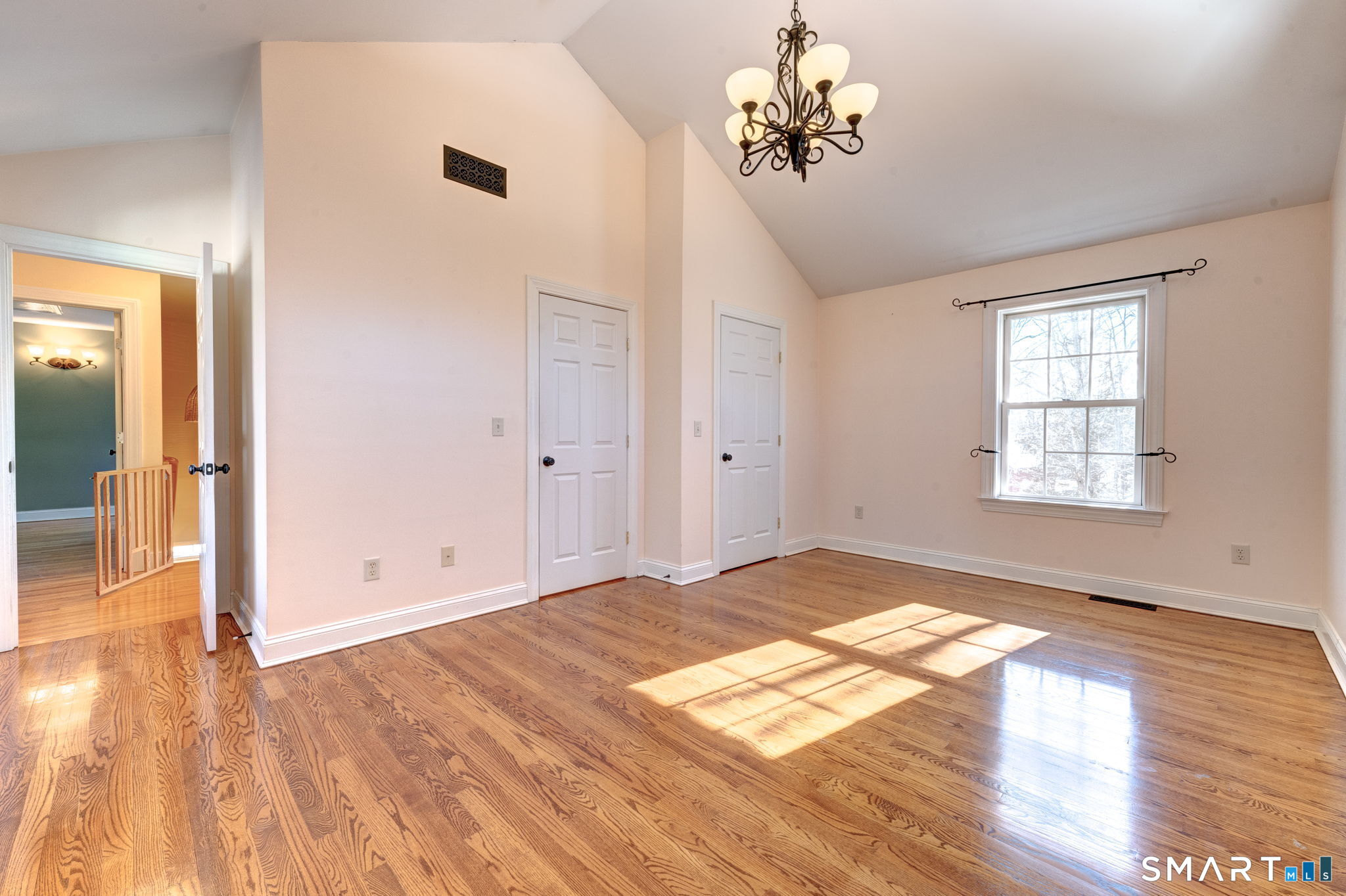 353 Warrenville Road Mansfield, CT 06250 - Photo 26 of 40 a view of empty room with wooden floor and fan