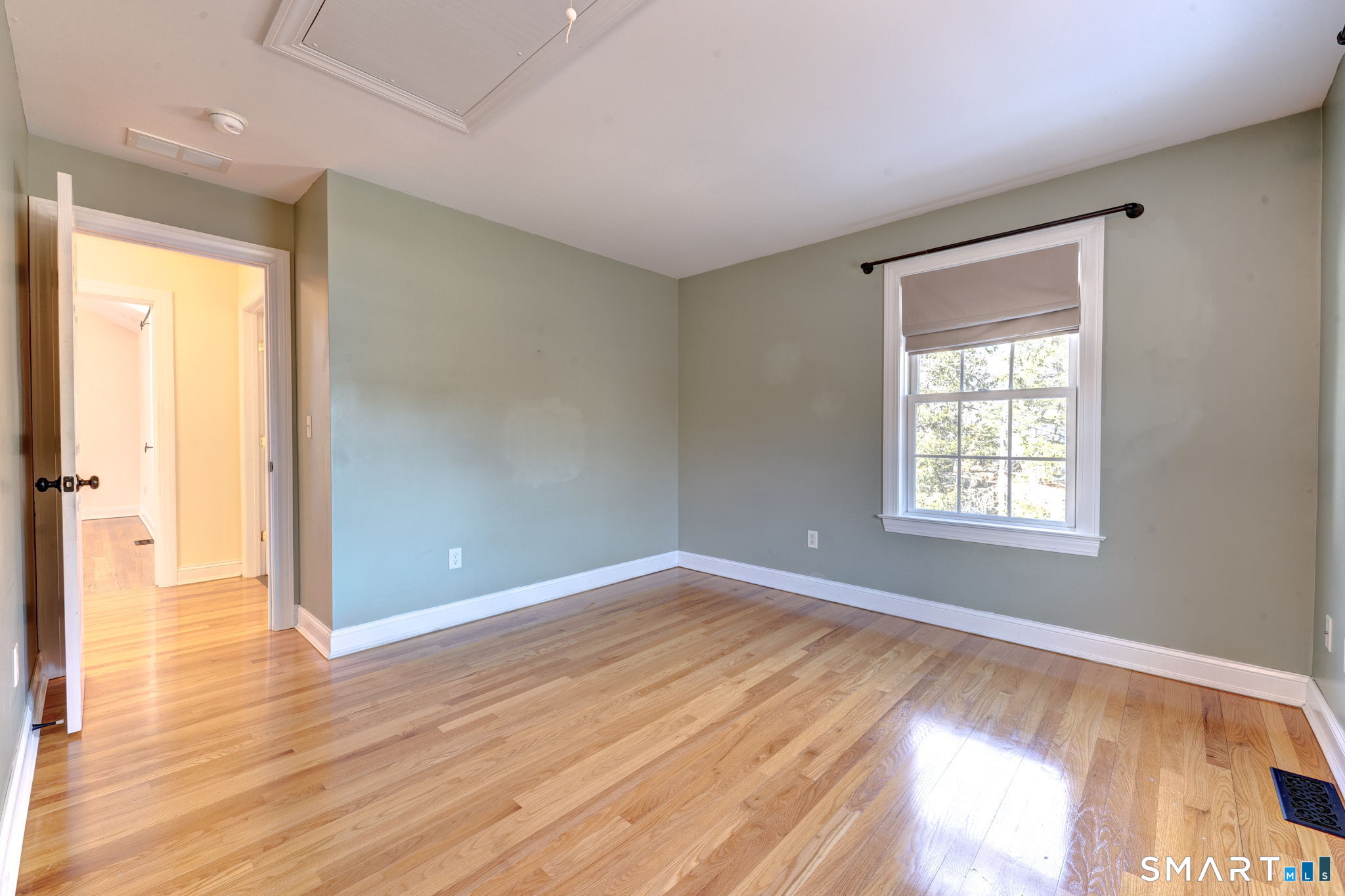 353 Warrenville Road Mansfield, CT 06250 - Photo 31 of 40 a view of an empty room with wooden floor and a window