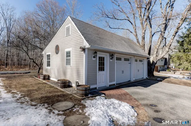 a view of a house with a yard covered with snow