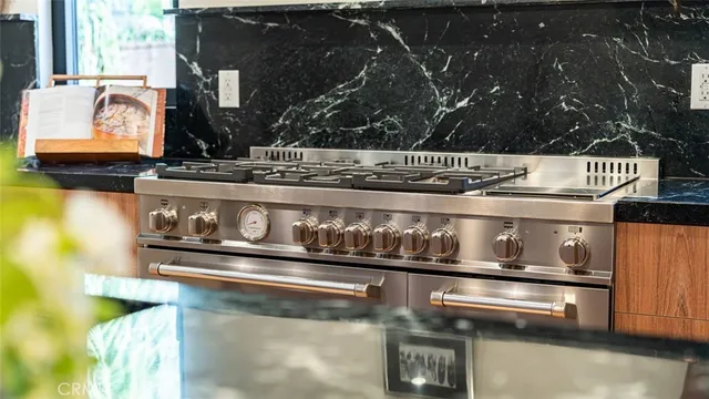 a kitchen with kitchen island granite countertop a counter top space and stainless steel appliances