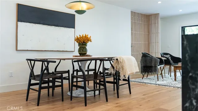 a living room with furniture and a painting on the wall