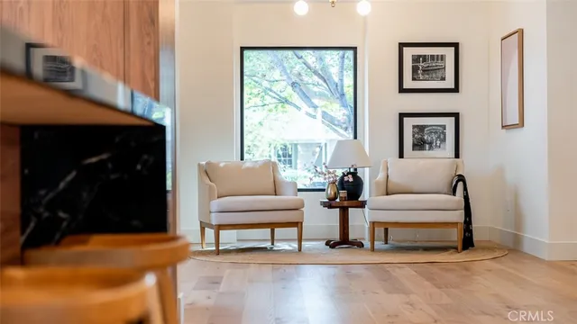 a view of wooden floor with a table and chairs