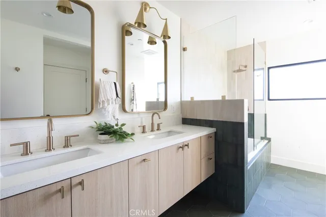 a bedroom with a bed a dresser and mirror