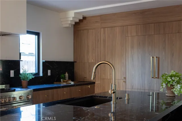a kitchen with kitchen island granite countertop a table and chairs in it