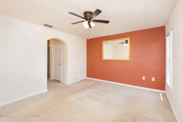 a living room with furniture and a dining table