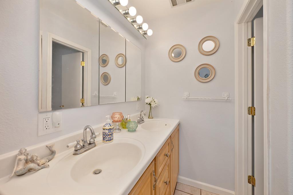 3641 Catlett Road Pleasant Grove, CA 95668 - Photo 15 of 29 a bathroom with a sink and a mirror