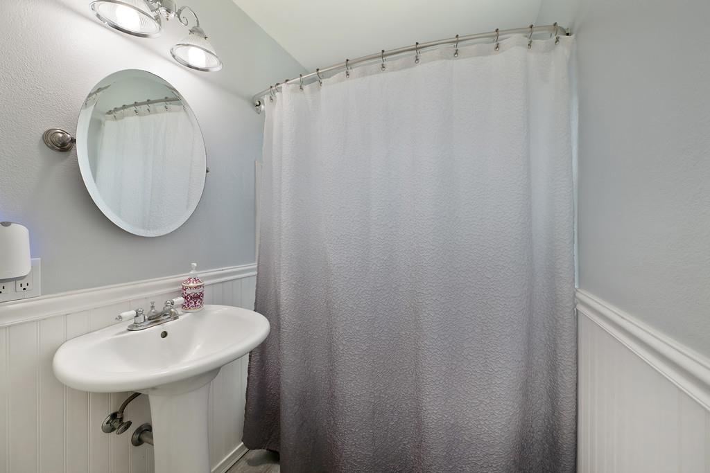 3641 Catlett Road Pleasant Grove, CA 95668 - Photo 10 of 29 a bathroom with a sink a mirror a vanity and a shower