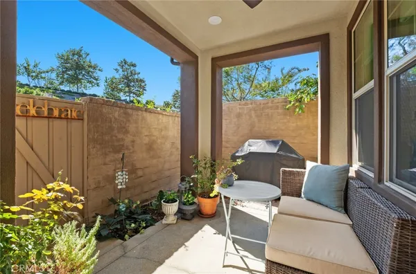 a balcony with furniture and a potted plant