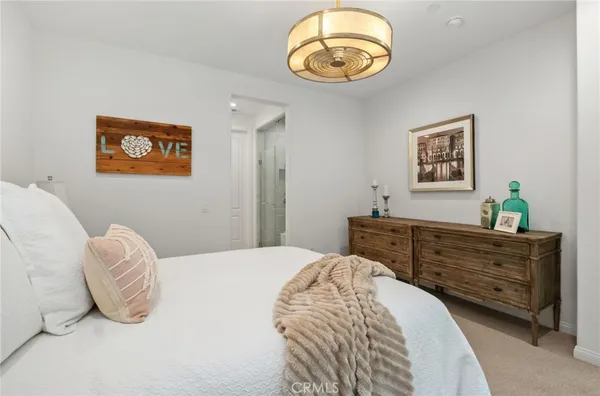 a bedroom with a bed and a painting on the wall