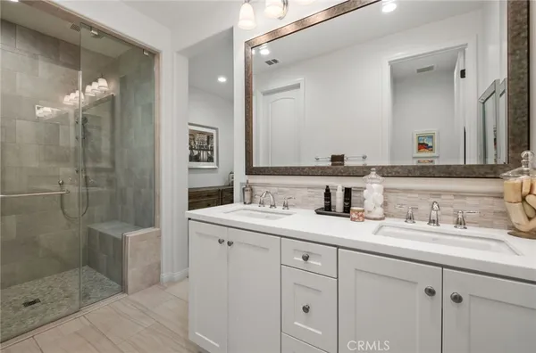 a bathroom with a shower sink and mirror