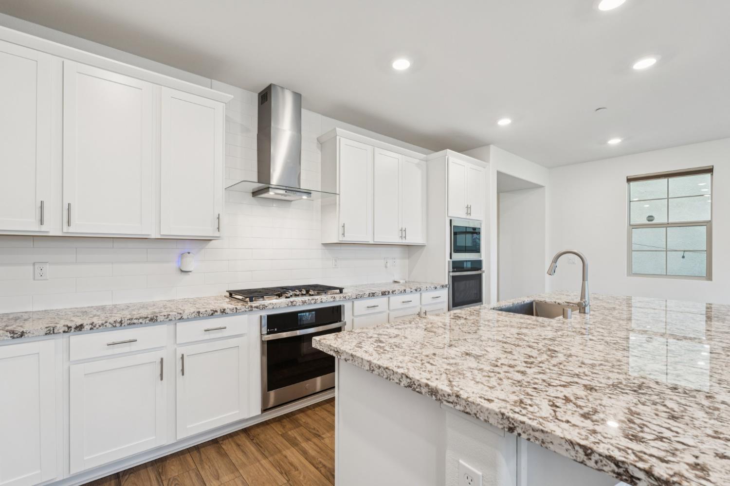 10458 Oboe Way Elk Grove, CA 95757 - Photo 13 of 38 a kitchen with stainless steel appliances granite countertop a sink stove and cabinets