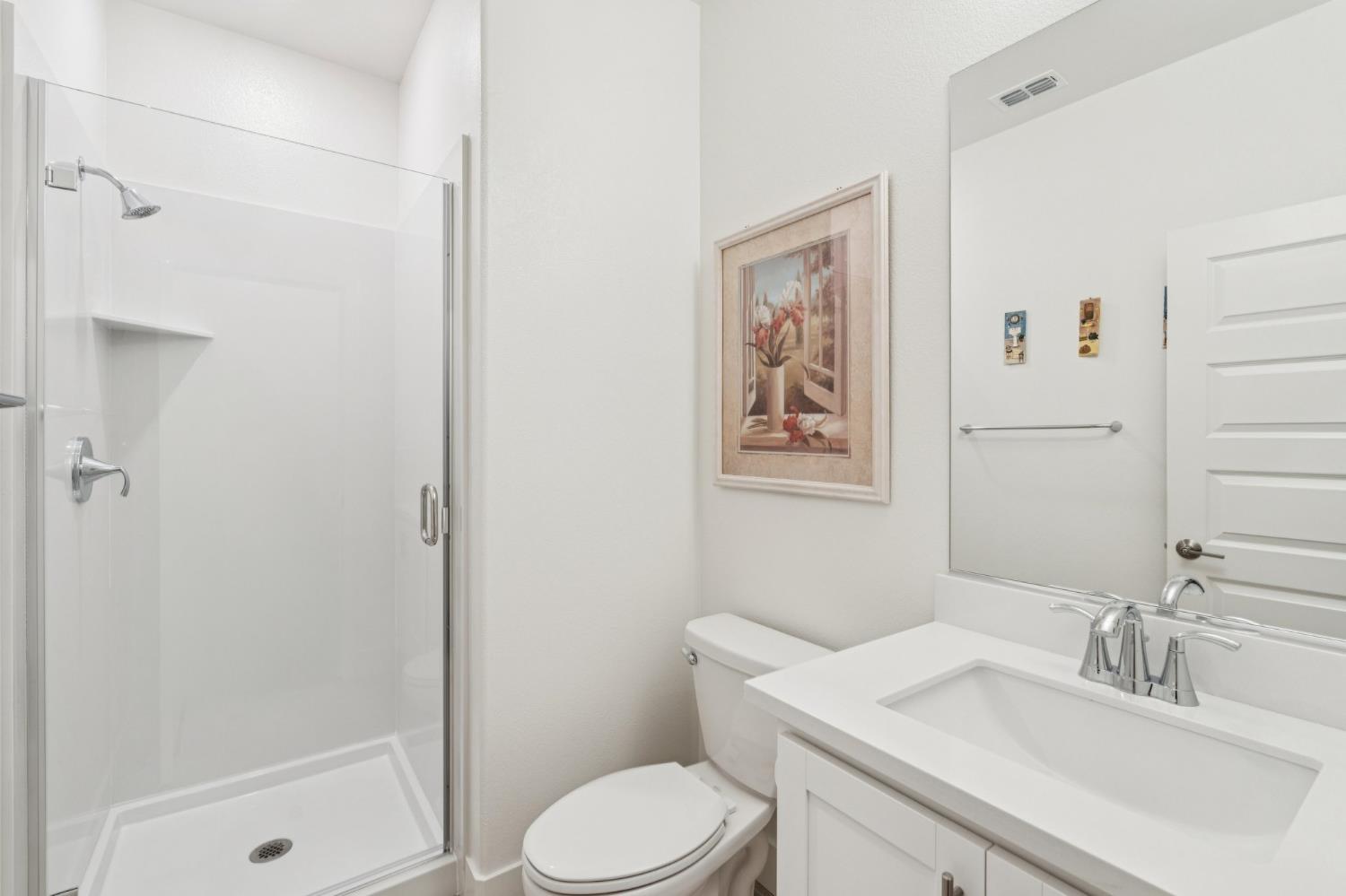 10458 Oboe Way Elk Grove, CA 95757 - Photo 14 of 38 a bathroom with a sink toilet and shower