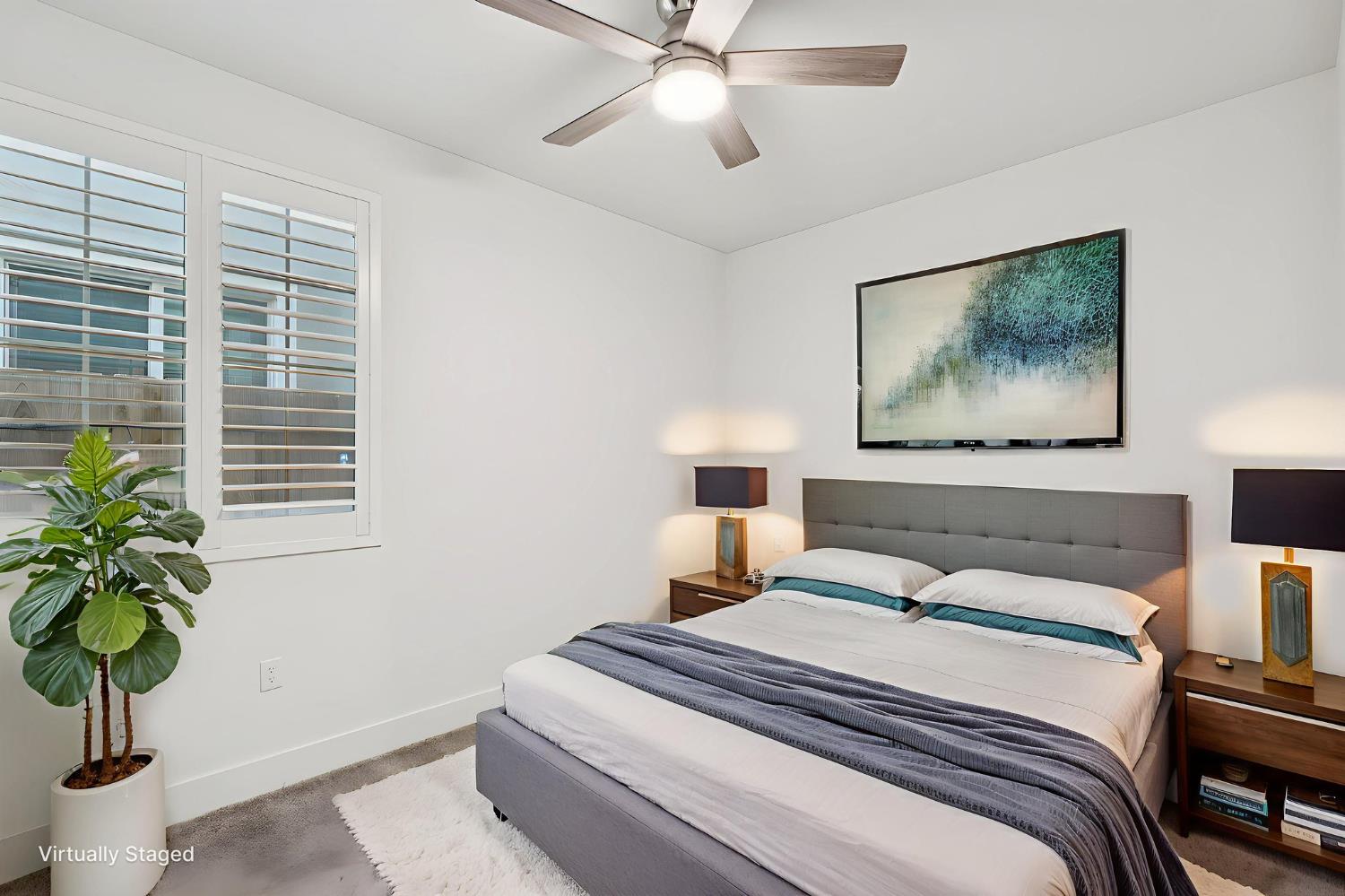 10458 Oboe Way Elk Grove, CA 95757 - Photo 15 of 38 a bedroom with a bed and a potted plant