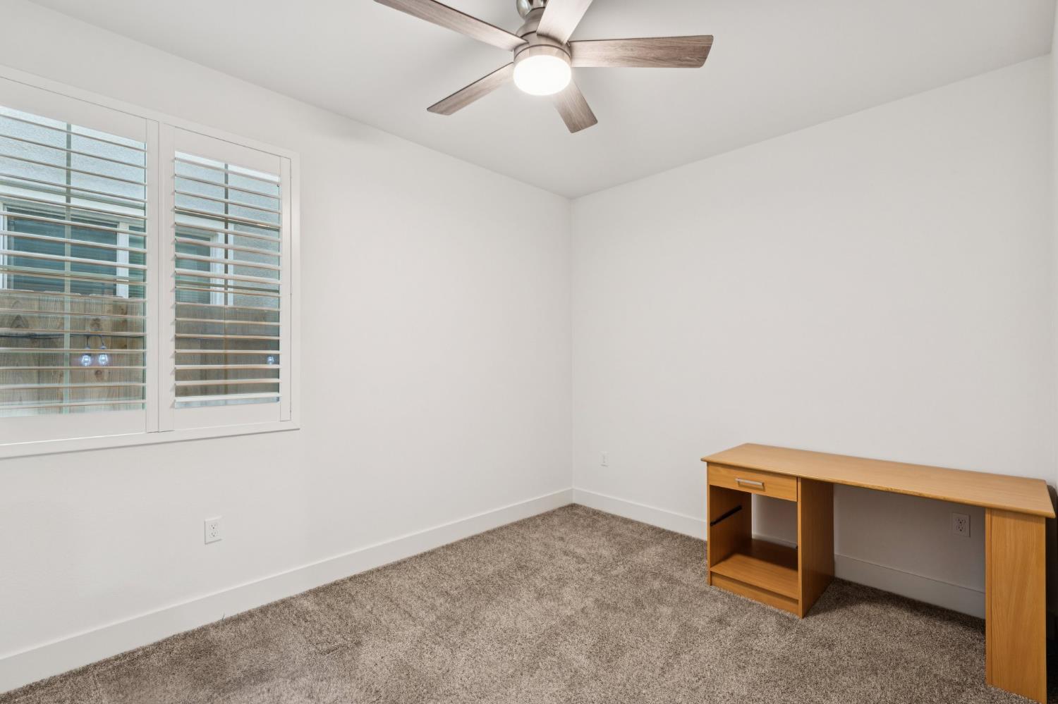 10458 Oboe Way Elk Grove, CA 95757 - Photo 16 of 38 a room with a window and a ceiling fan