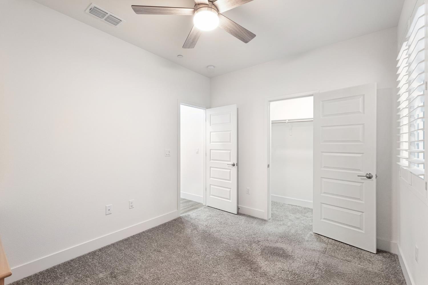 10458 Oboe Way Elk Grove, CA 95757 - Photo 17 of 38 an empty room with windows and fan