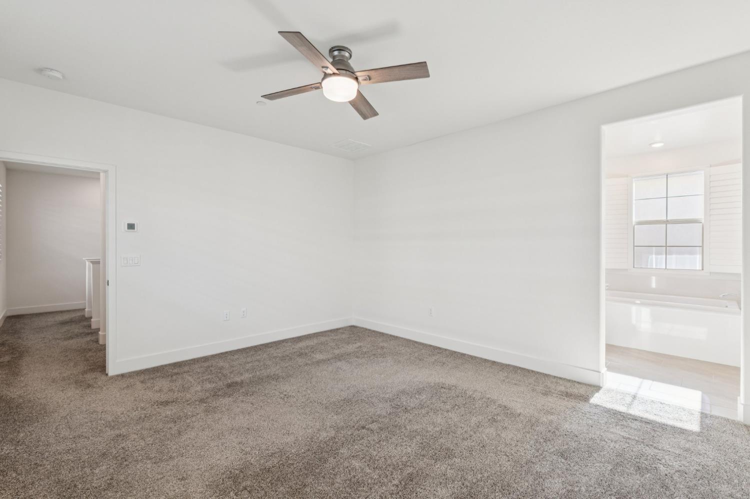 10458 Oboe Way Elk Grove, CA 95757 - Photo 21 of 38 an empty room with a empty space and a ceiling fan