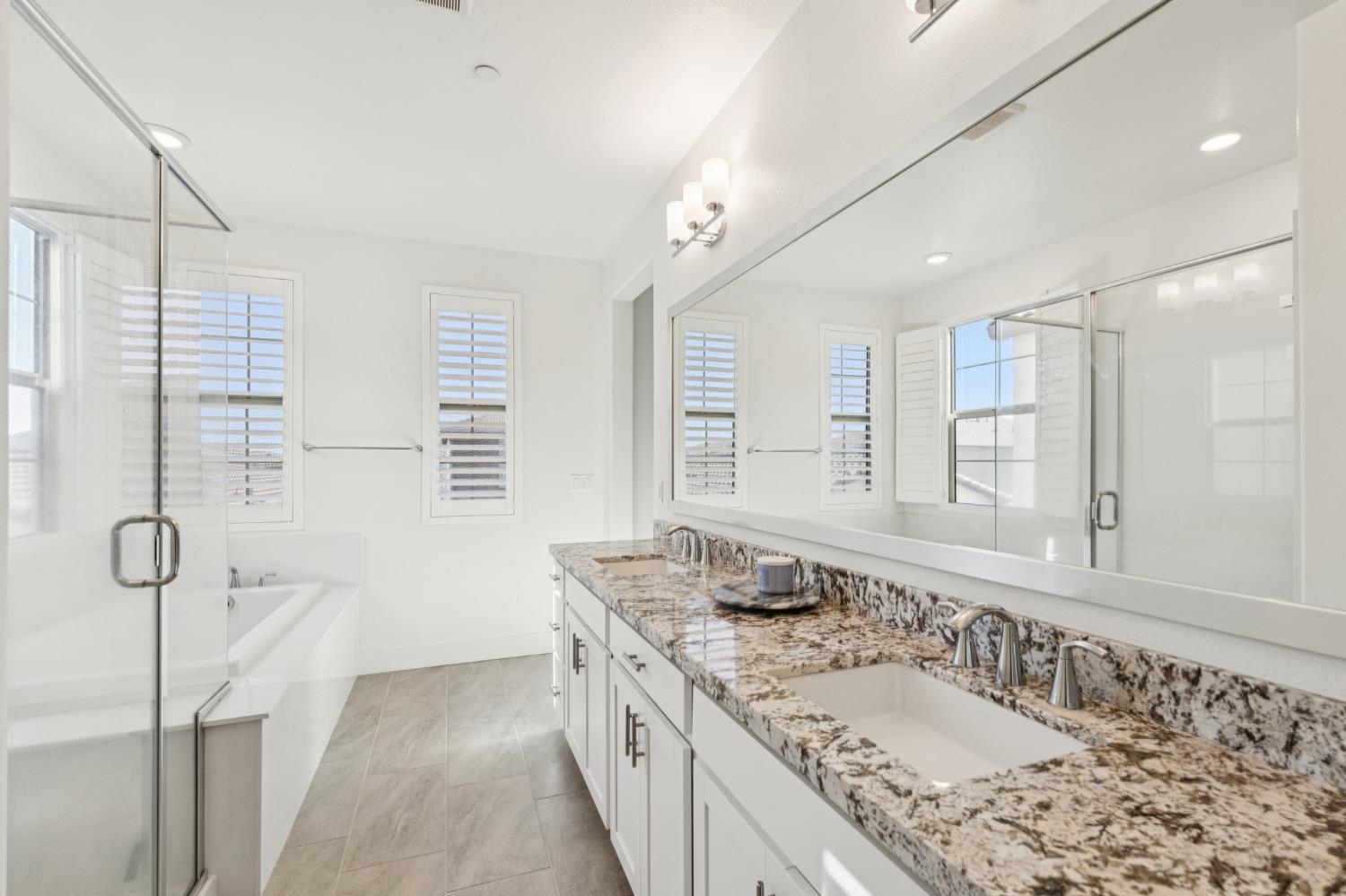 10458 Oboe Way Elk Grove, CA 95757 - Photo 22 of 38 a bathroom with a granite countertop sink mirror and double