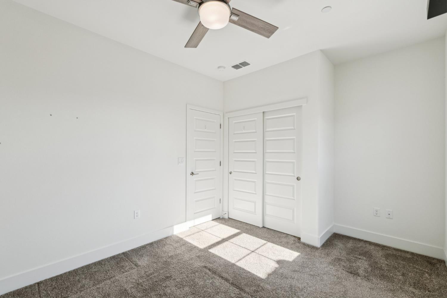 10458 Oboe Way Elk Grove, CA 95757 - Photo 27 of 38 an empty room with closet and fan