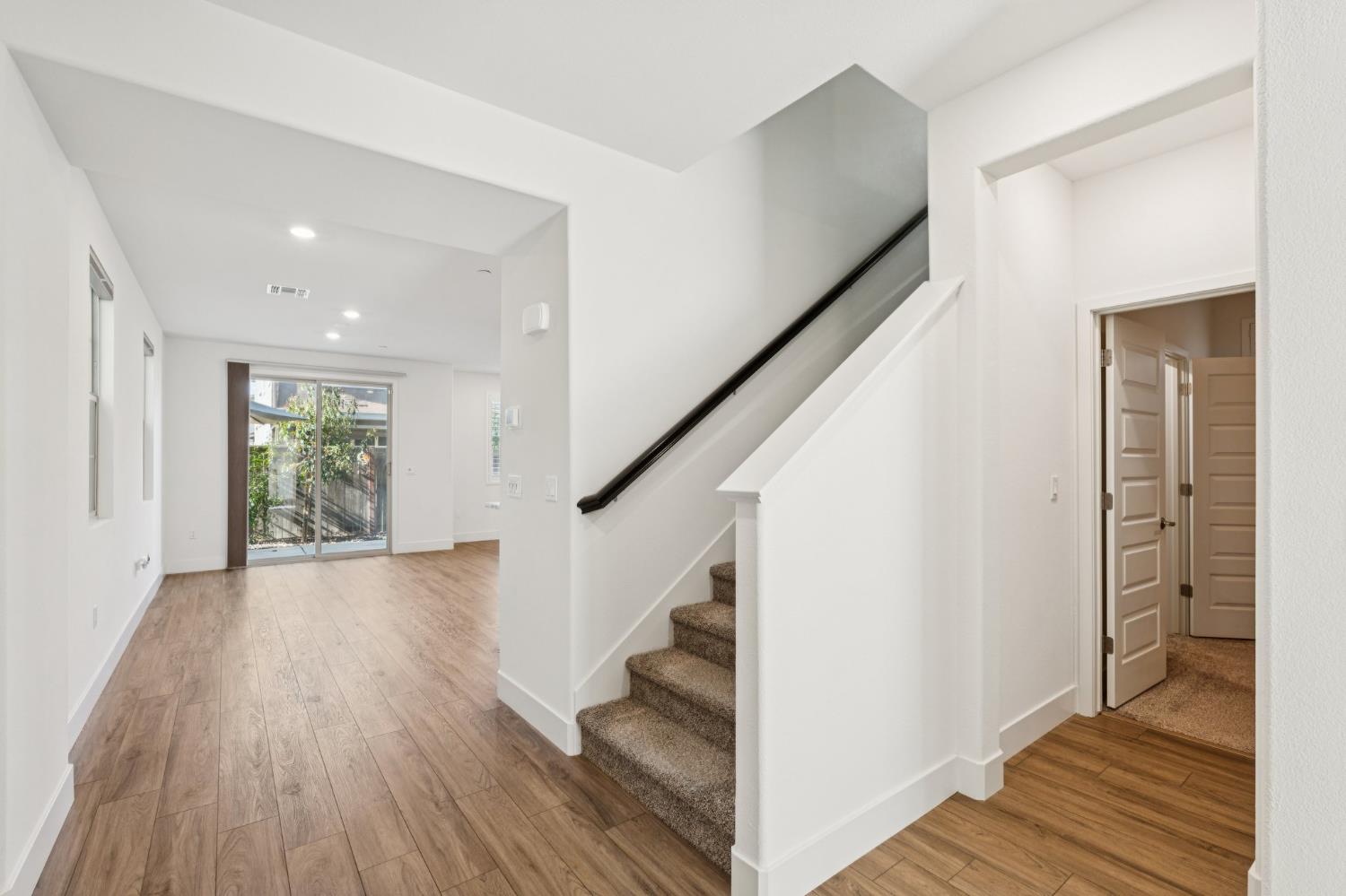 10458 Oboe Way Elk Grove, CA 95757 - Photo 3 of 38 a view of entryway with wooden floor and stairs