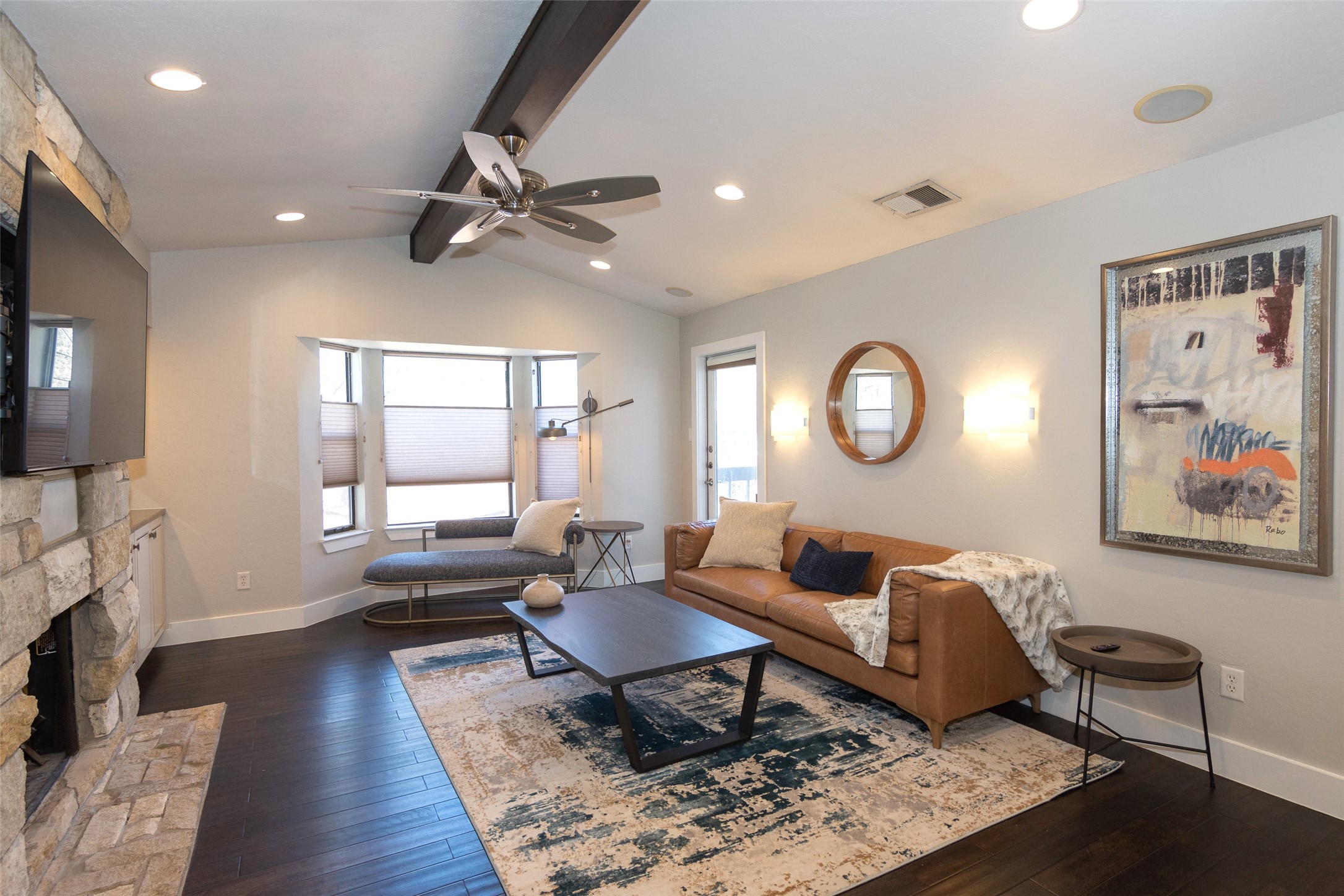 a living room with furniture a rug and a window