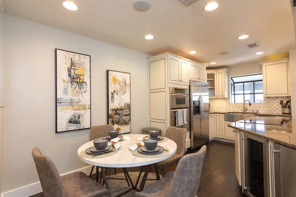 a kitchen with sink and refrigerator