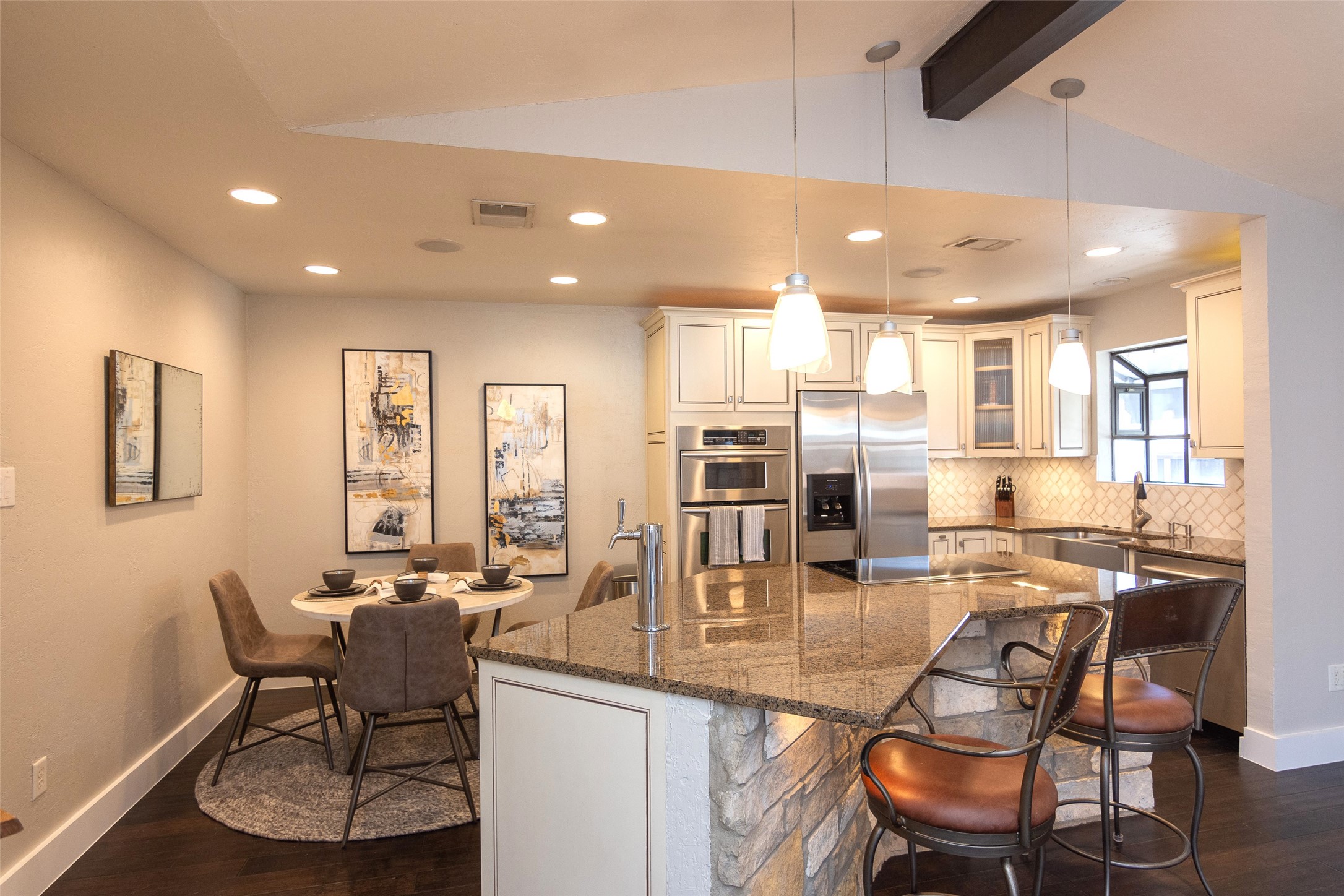 2410 Enfield Road, Unit 10 Austin, TX 78703 - Photo 15 of 40 a kitchen with stainless steel appliances kitchen island granite countertop a dining table chairs and granite counter tops