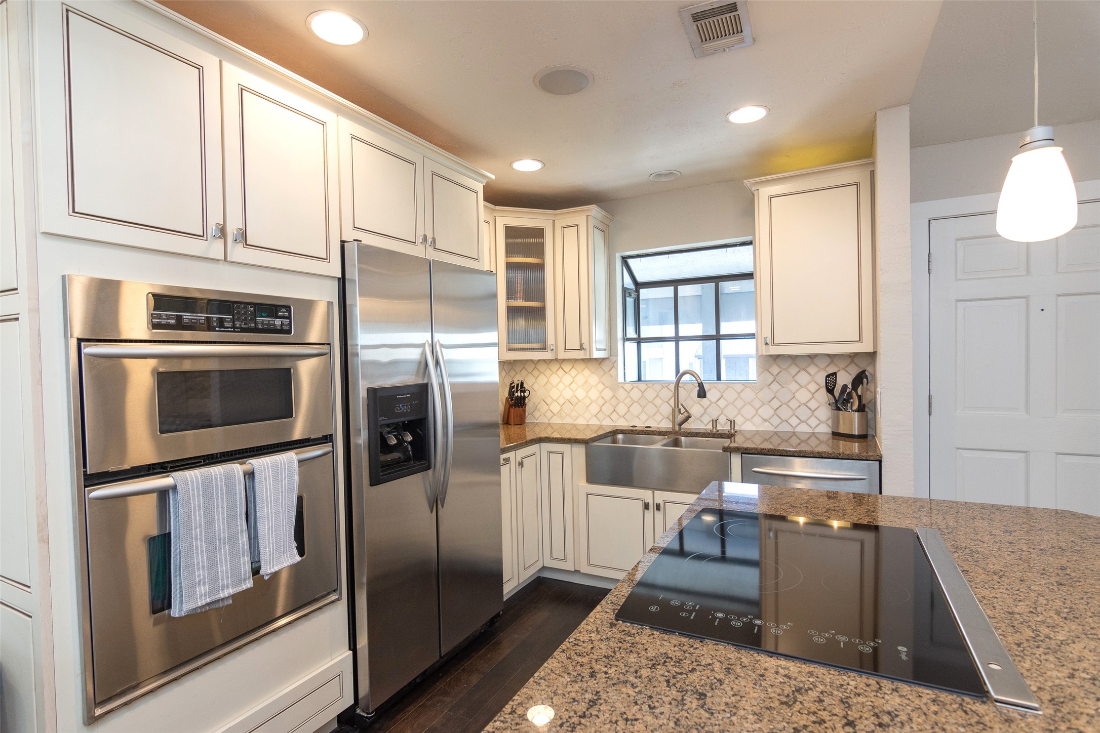 2410 Enfield Road, Unit 10 Austin, TX 78703 - Photo 17 of 40 a kitchen with stainless steel appliances granite countertop a refrigerator and a stove top oven