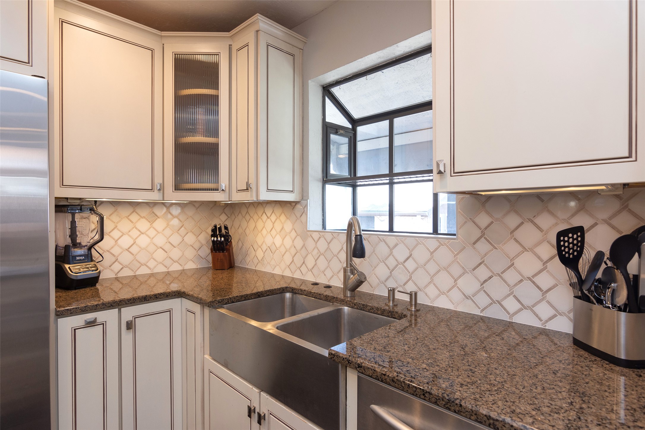 2410 Enfield Road, Unit 10 Austin, TX 78703 - Photo 20 of 40 a kitchen with a sink and cabinets