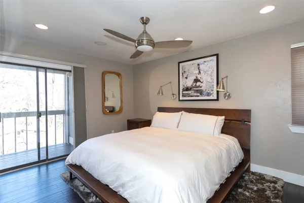 a bedroom with a large bed and a large window