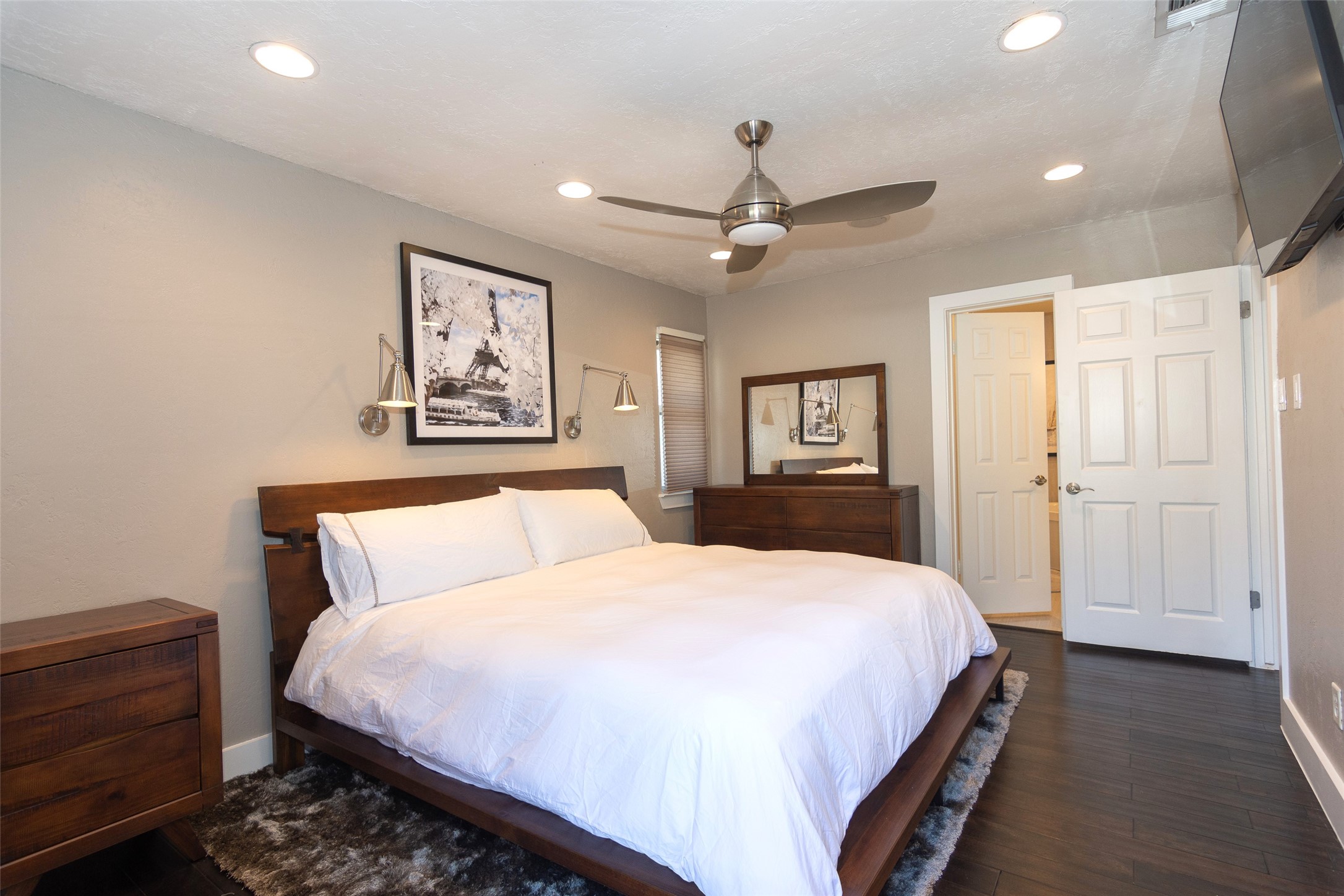 2410 Enfield Road, Unit 10 Austin, TX 78703 - Photo 24 of 40 a bedroom with a large bed and a chandelier